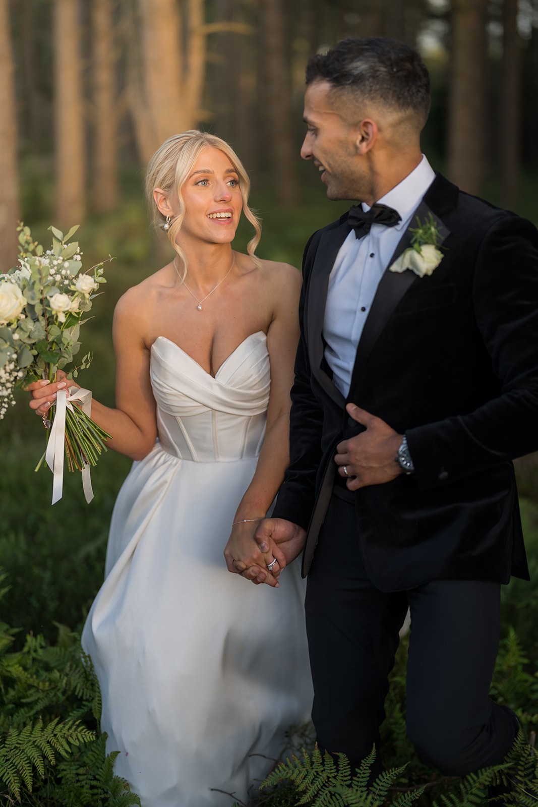 Bride laughing beside the groom during their wedding ceremony