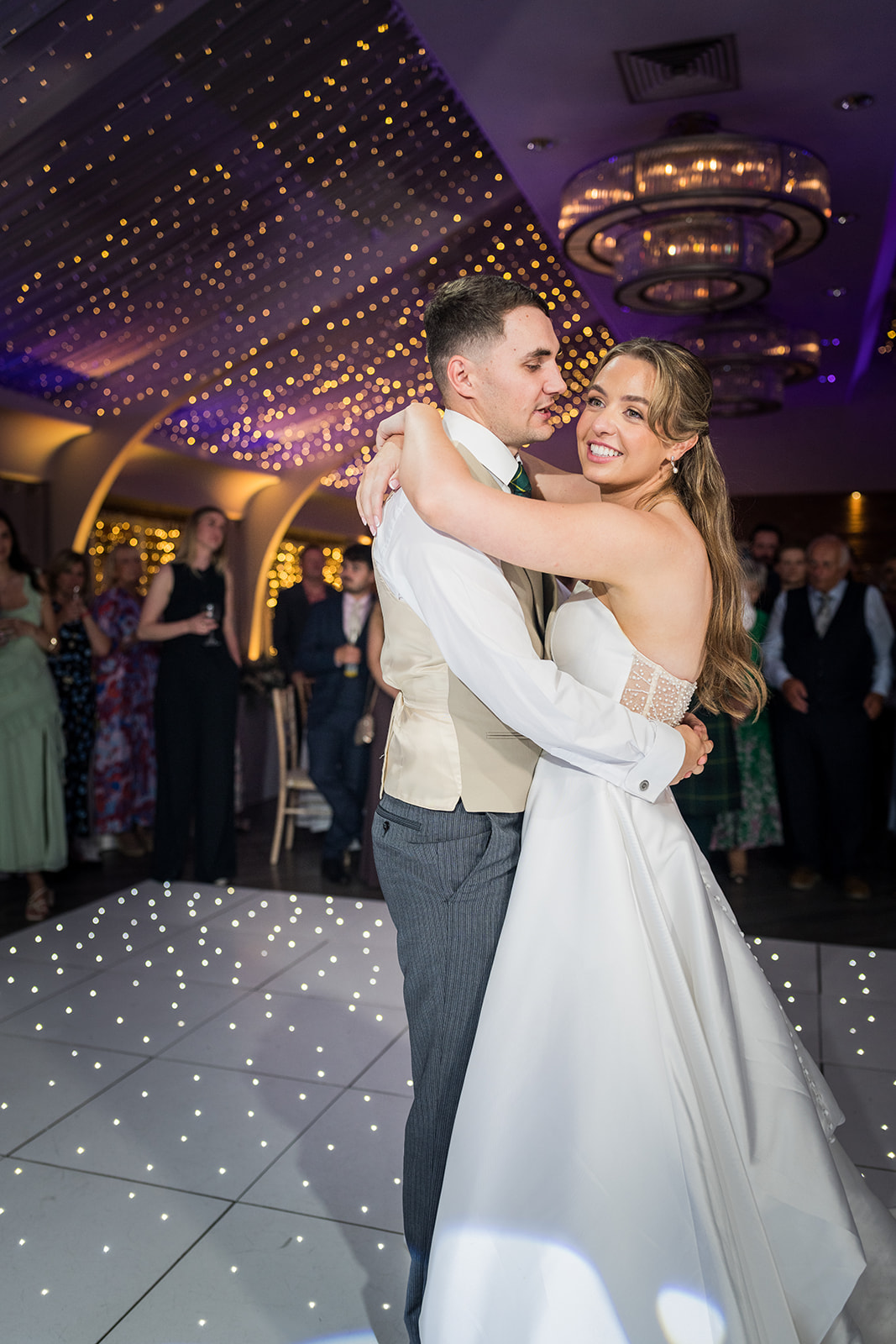 Newlyweds embracing on the evening dance floor