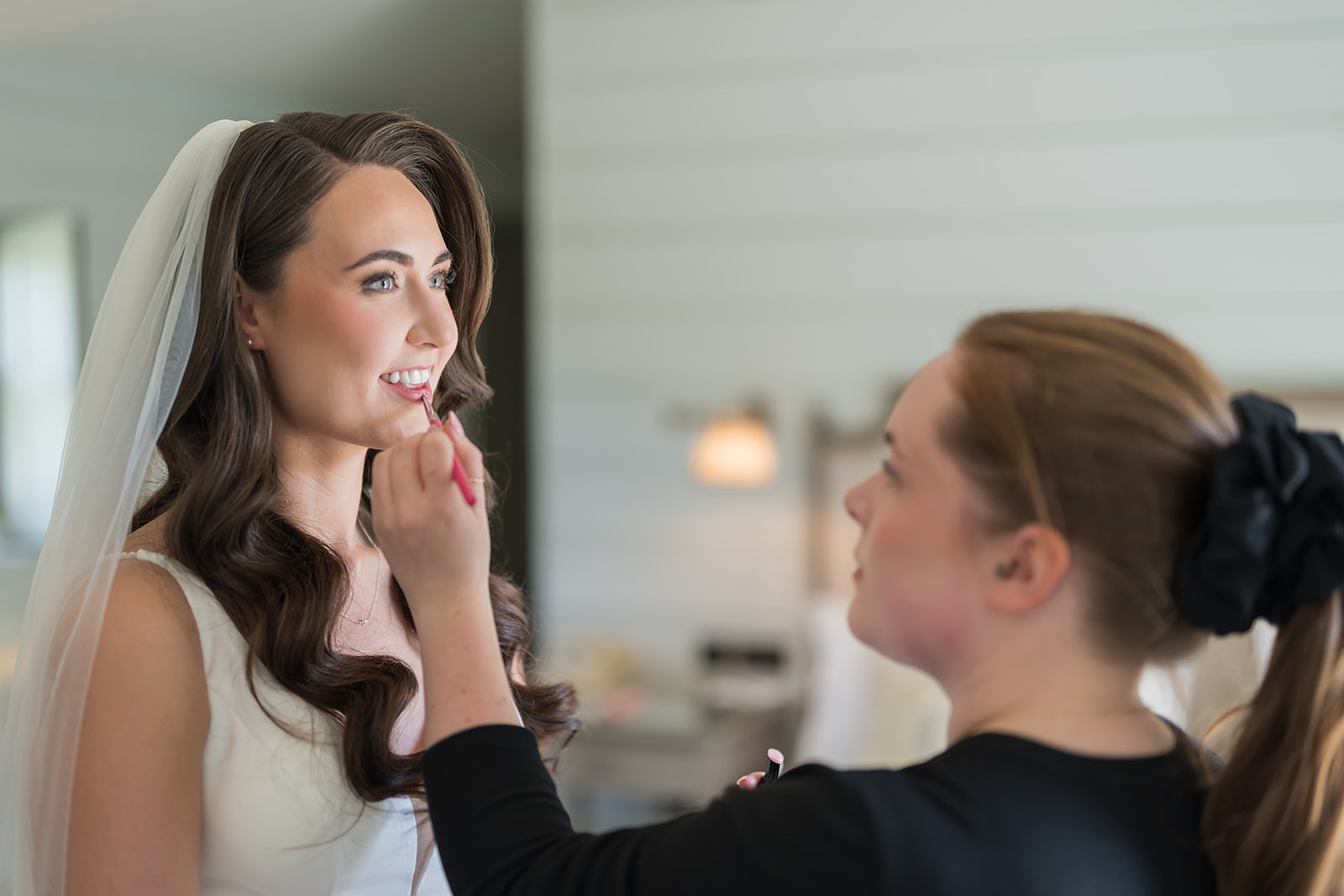 Bride having her makeup applied before the ceremony
