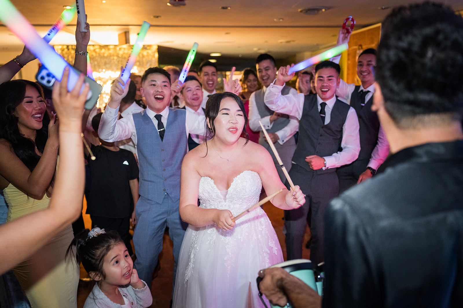 Guests waving colourful light sticks on the dance floor