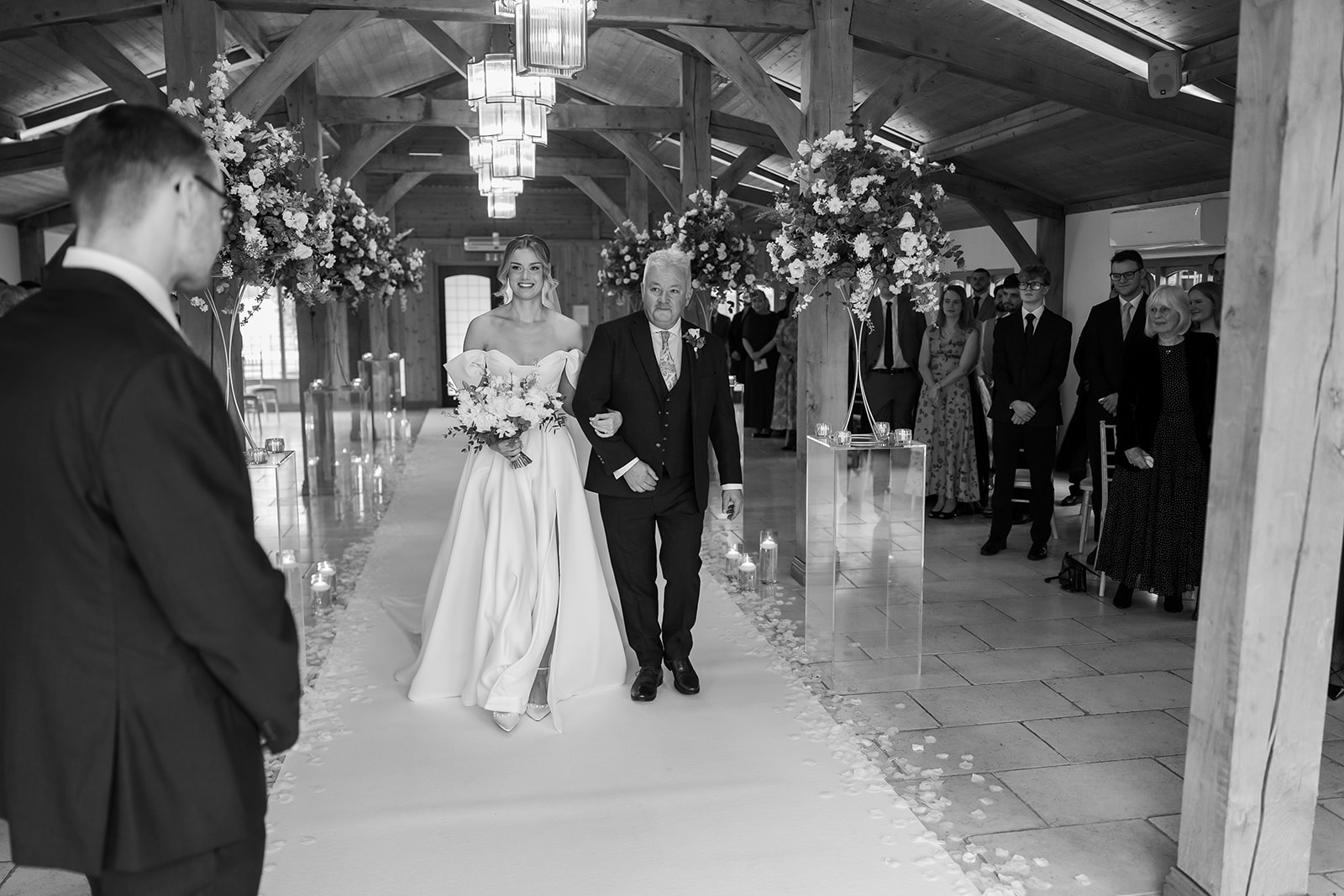 Black-and-white photograph of newlyweds leaving their ceremony