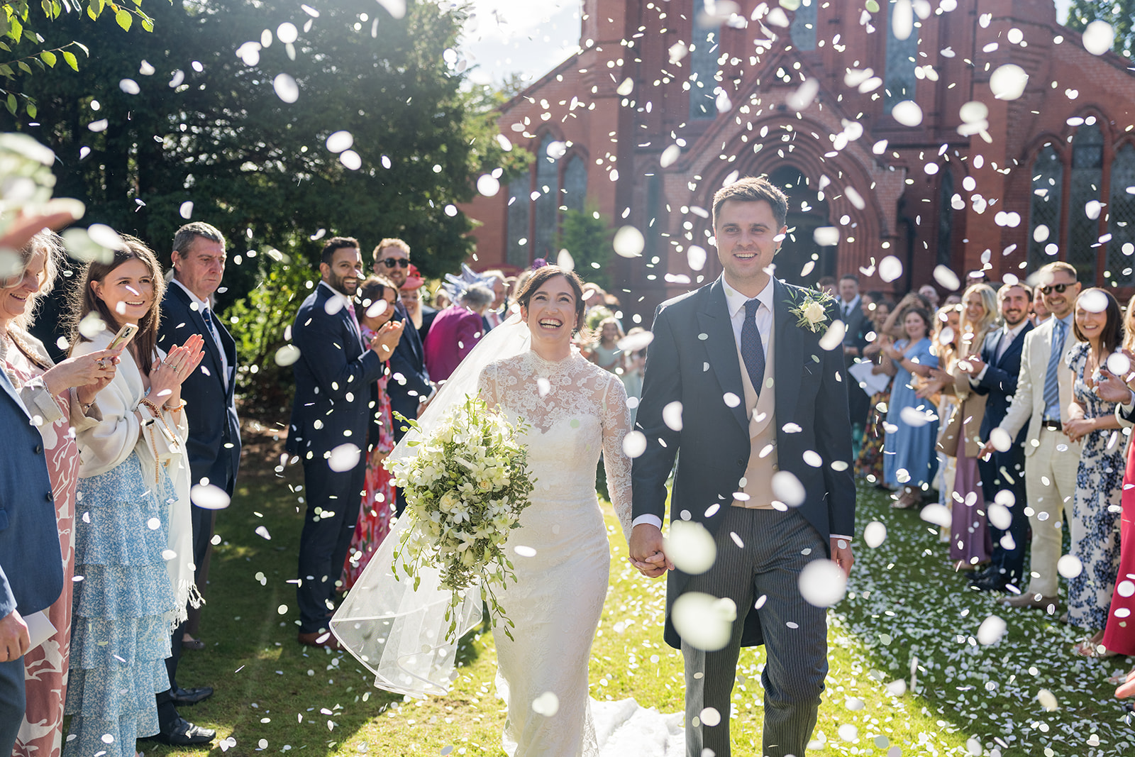Wedding videography in the North West showing a videographer recording a couple during their wedding ceremony.